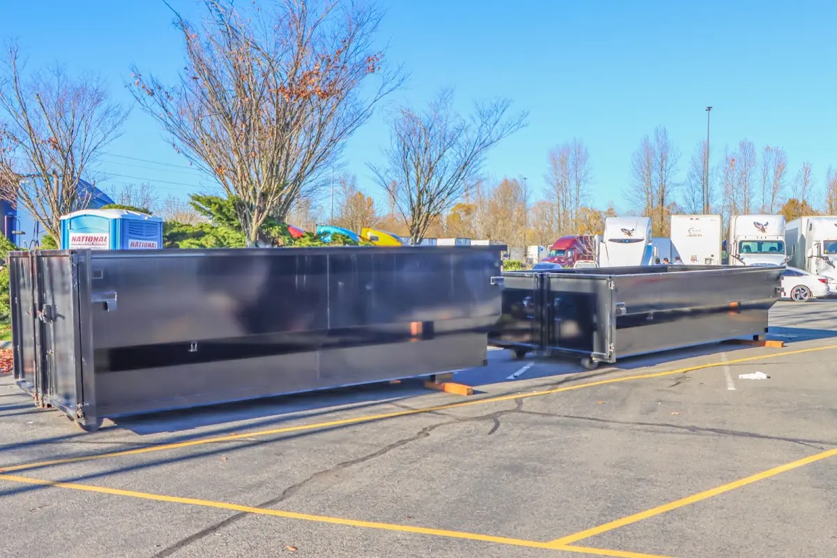 Professional dumpster rental service with roll-off container on residential driveway in Monterey Park